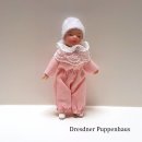 Porzellanbaby im rosa Anzug