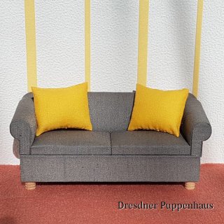Dunkelgraues Sofa mit 2 gelben Kissen