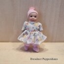 Baby mit Blumenkleid und Mütze
